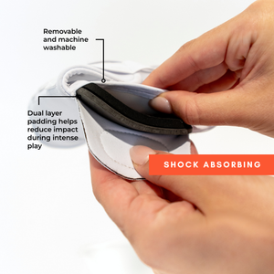 Hands removing dual layer shock absorbing foam insert from knee pad