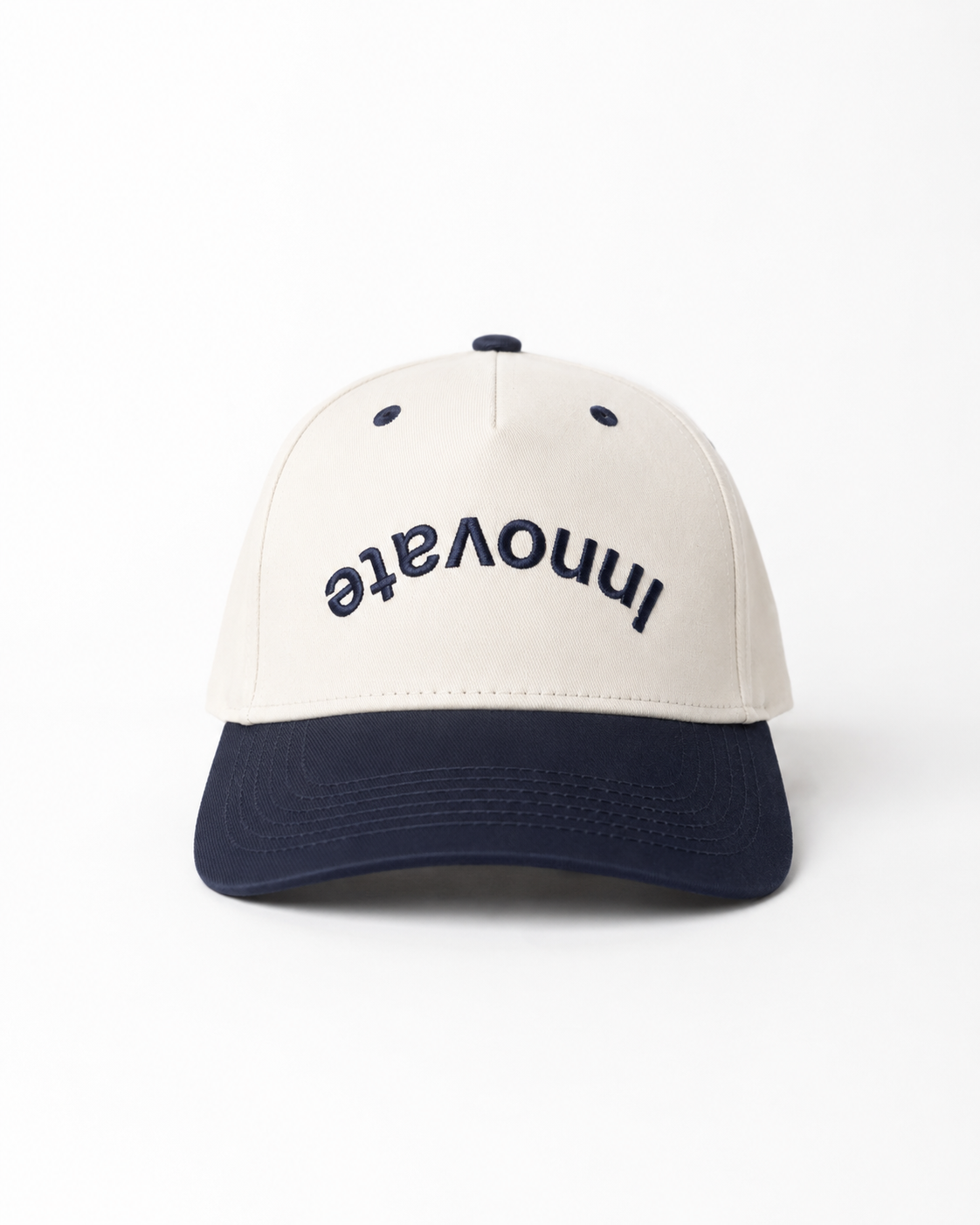 A baseball cap with an off-white crown and a navy blue brim, featuring the word 'Innovate' embroidered in navy blue on the front.